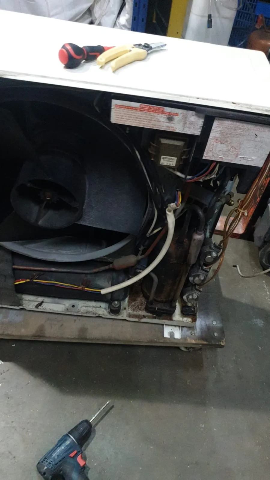 Outdoor condenser unit during electrical terminal inspection and repair