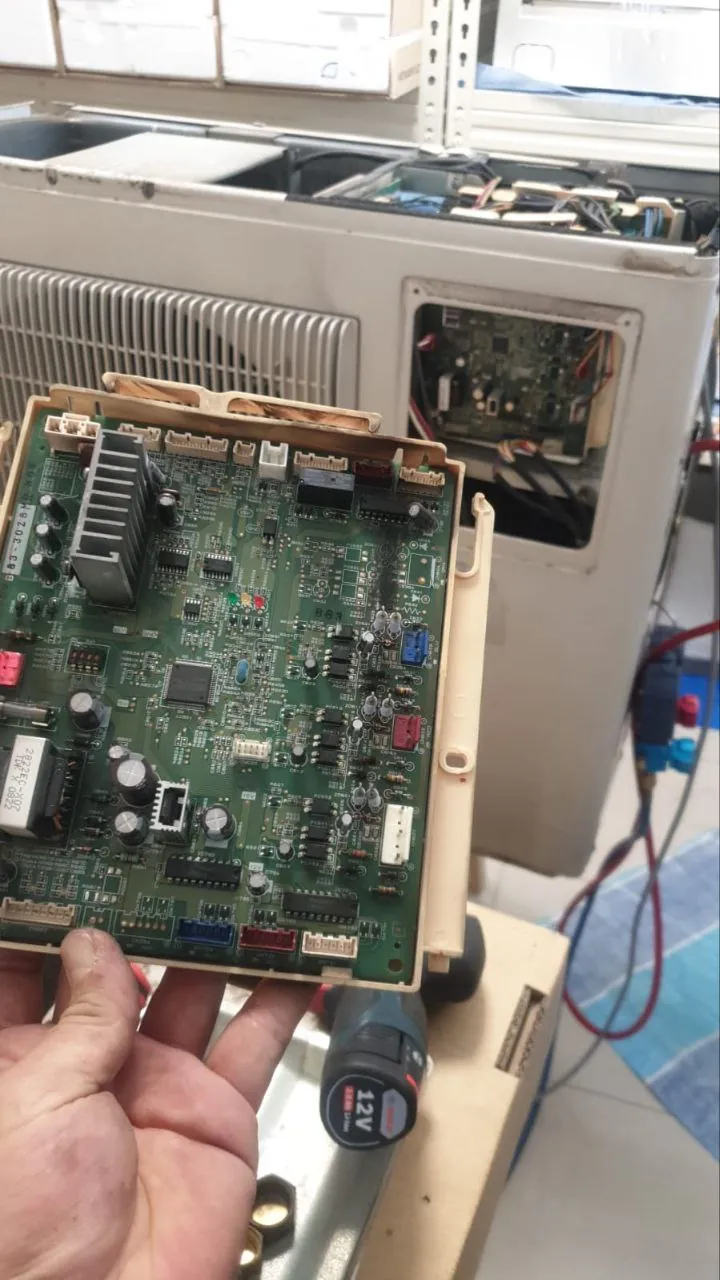 Outdoor unit PCB and capacitor area during electrical diagnostic
