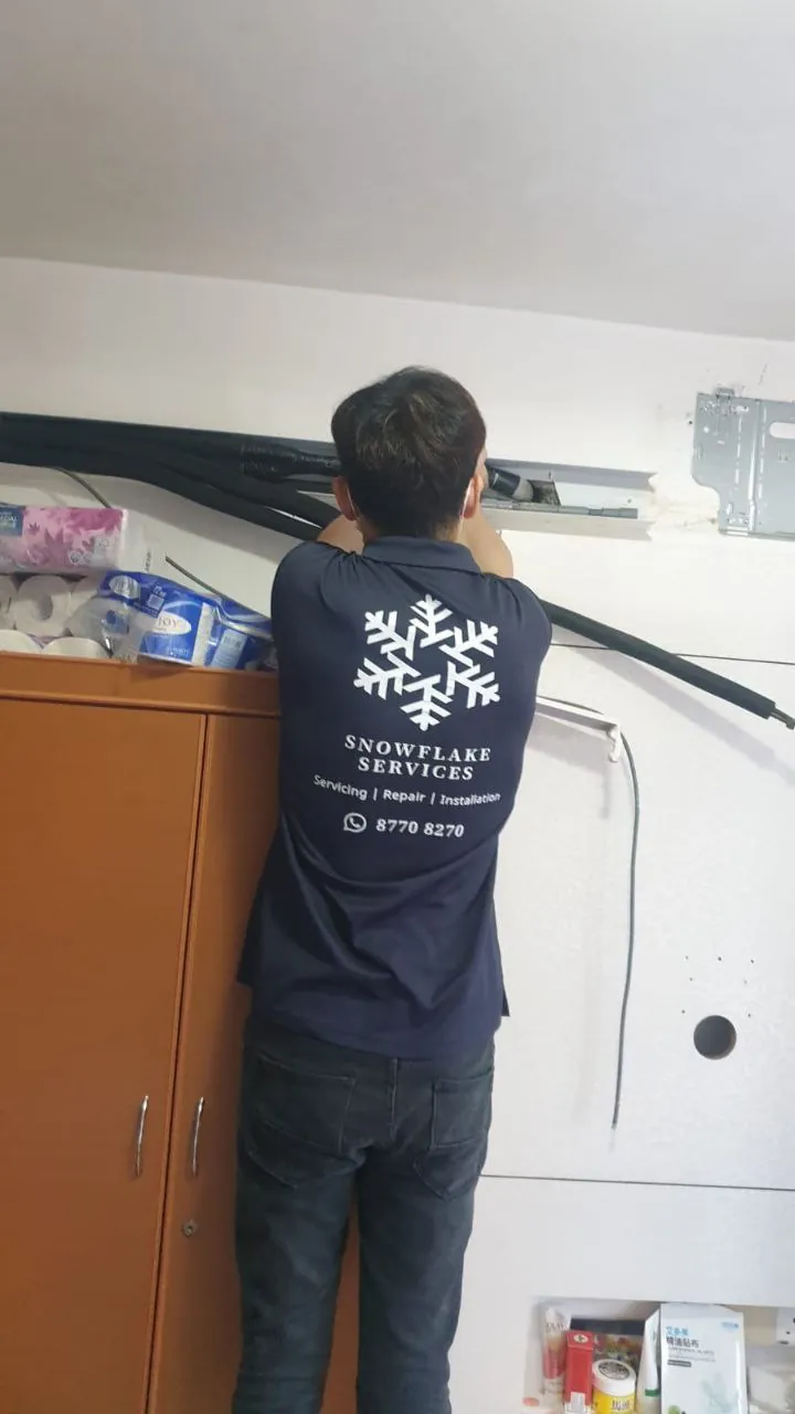Refrigerant piping run and joints during an aircon installation.