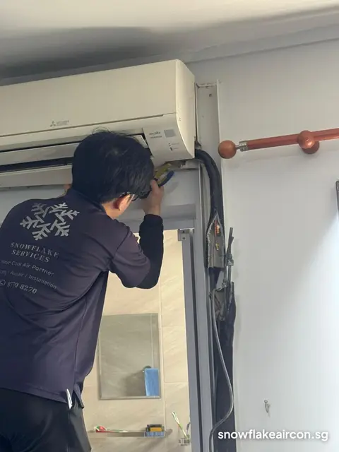 Technician working at a Mitsubishi Electric wall unit